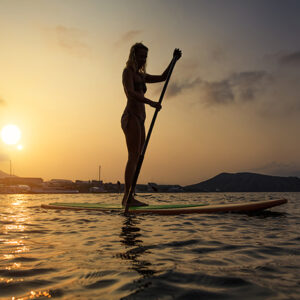 Silhouette of a beautiful woman on Stand Up Paddle Board. SUP.